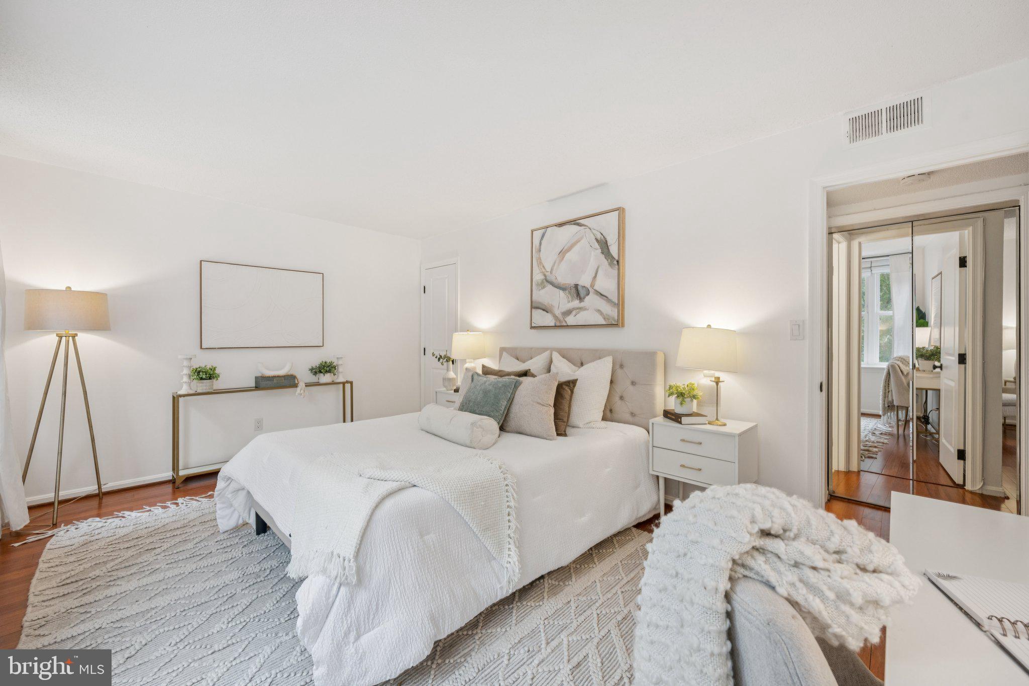 2630 Adams Mill Road Northwest, Unit 103 Washington, DC 20009 - Photo 14 of 24 a bedroom with a bed and a lamp