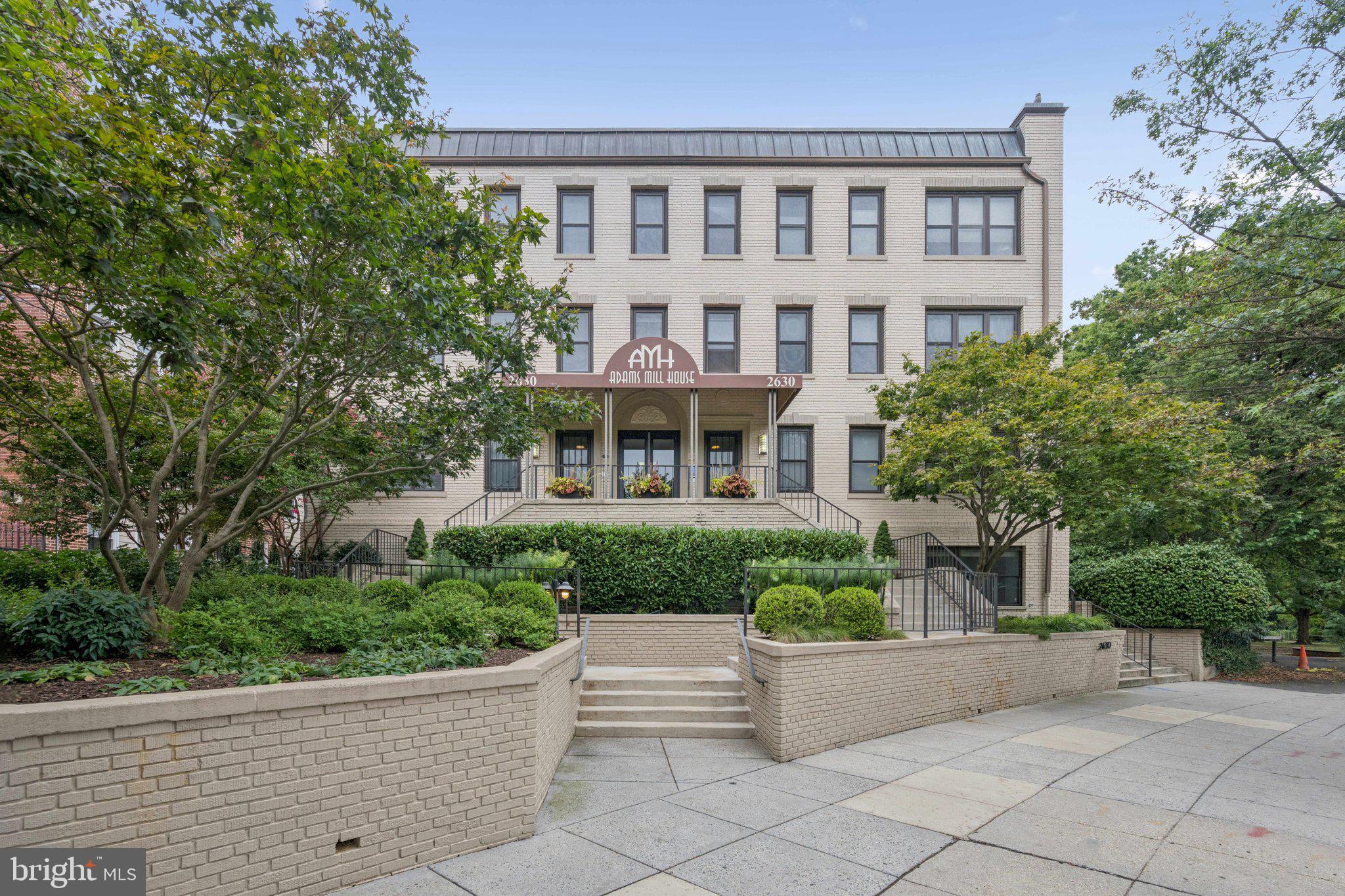 2630 Adams Mill Road Northwest, Unit 103 Washington, DC 20009 - Photo 22 of 24 front view of a house with a garden