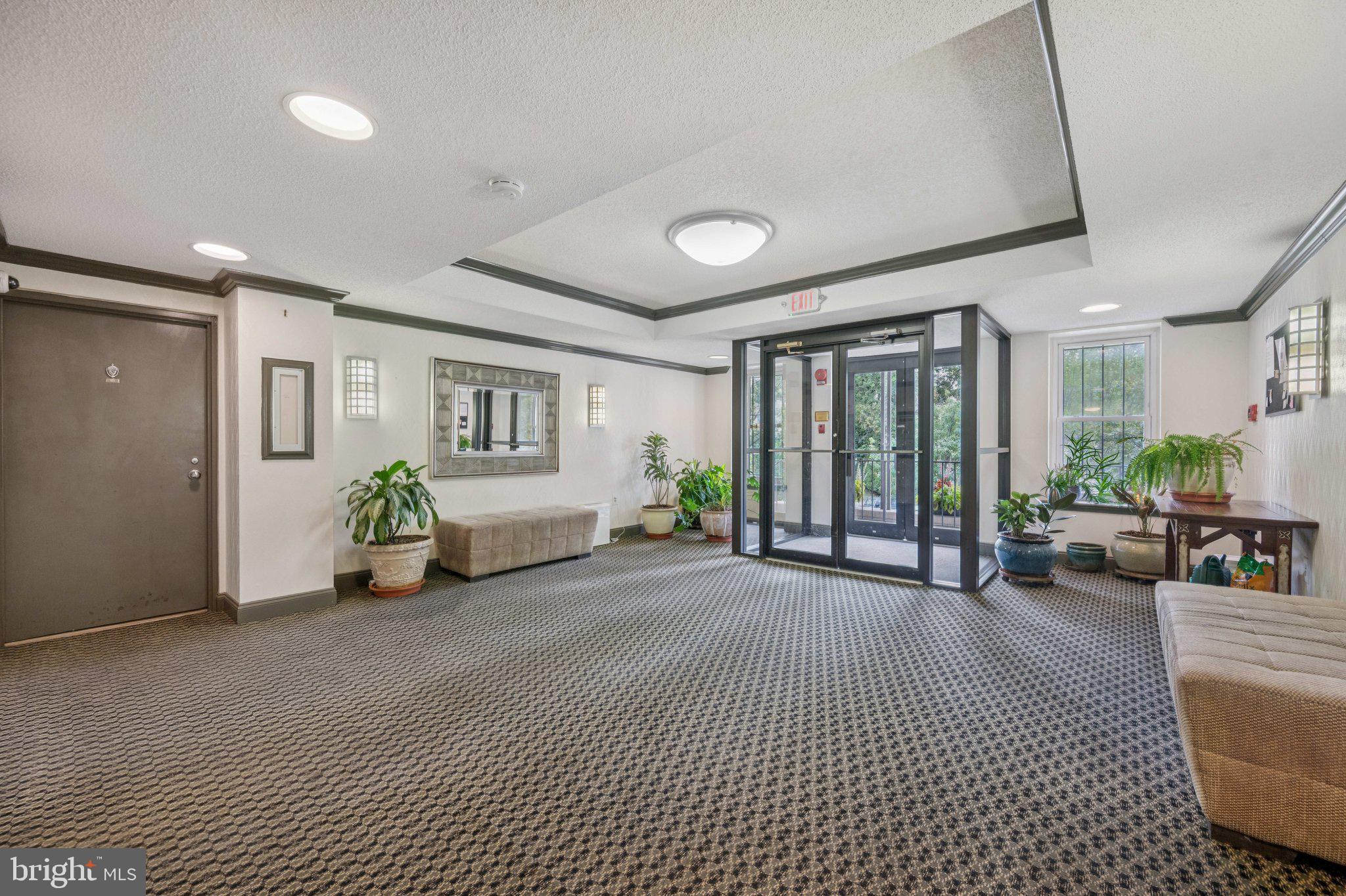 2630 Adams Mill Road Northwest, Unit 103 Washington, DC 20009 - Photo 23 of 24 a view of a livingroom with furniture and floor to ceiling window