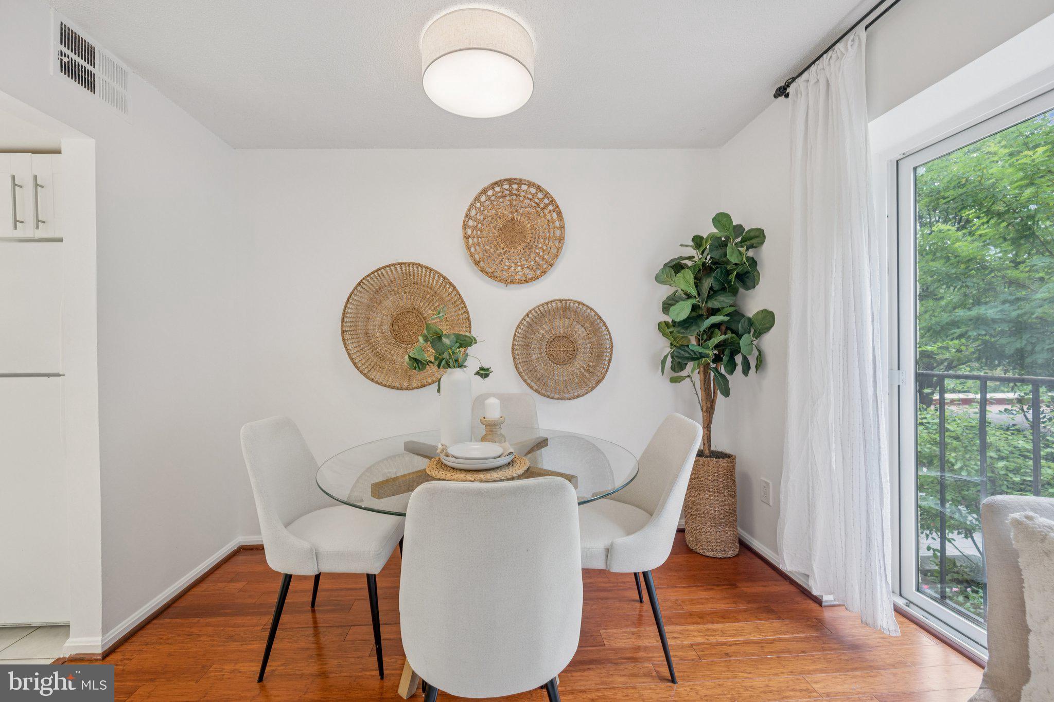2630 Adams Mill Road Northwest, Unit 103 Washington, DC 20009 - Photo 3 of 24 a view of a dining room with furniture window and wooden floor