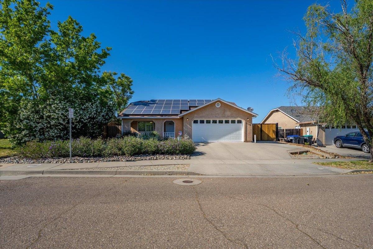 2110 Gentry Way Red Bluff, CA 96080 - Photo 28 of 47 a front view of a house with a yard and large trees