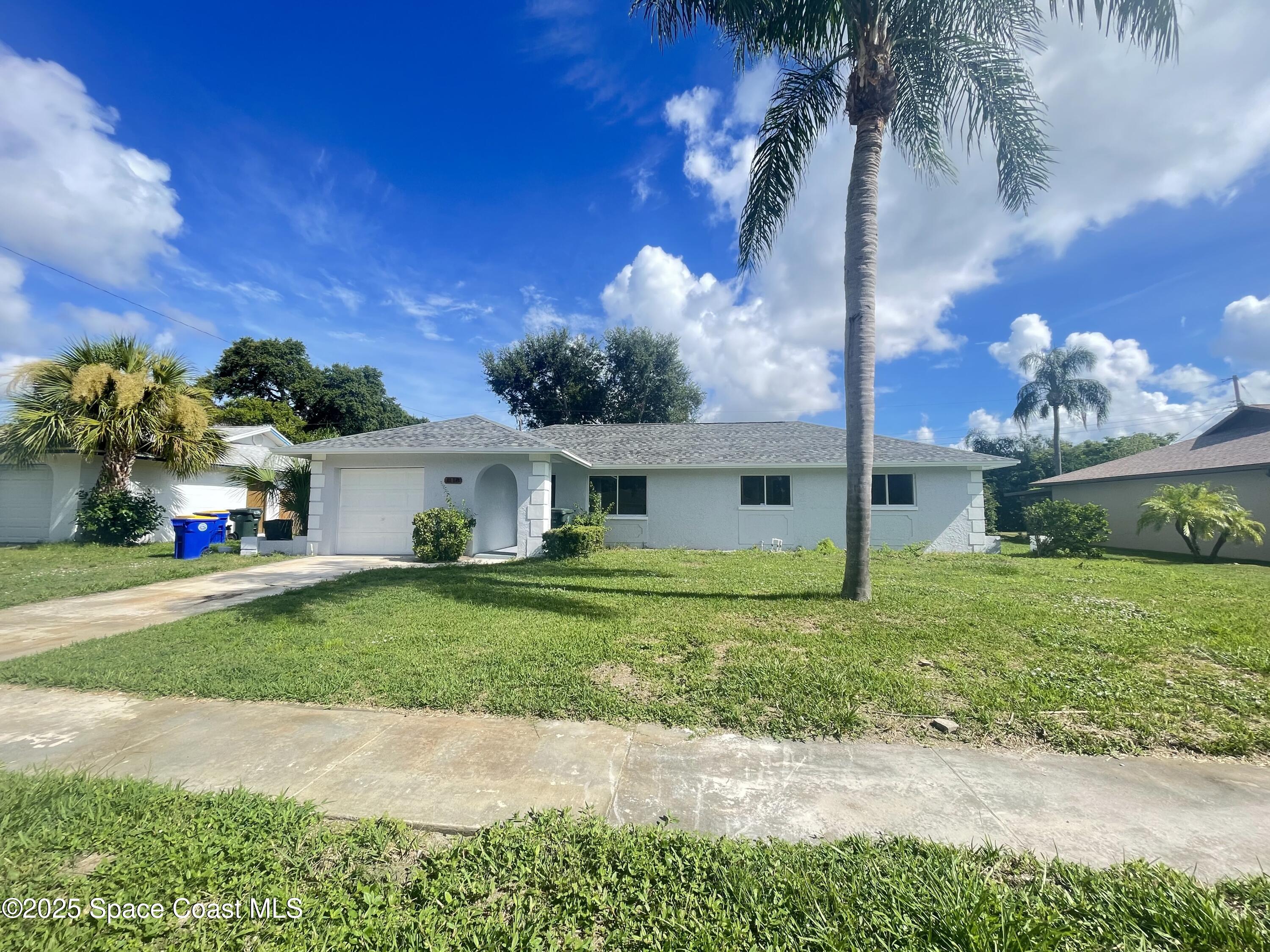 1118 Manatee Drive Rockledge, FL 32955 - Photo 1 of 17 a front view of a house with garden