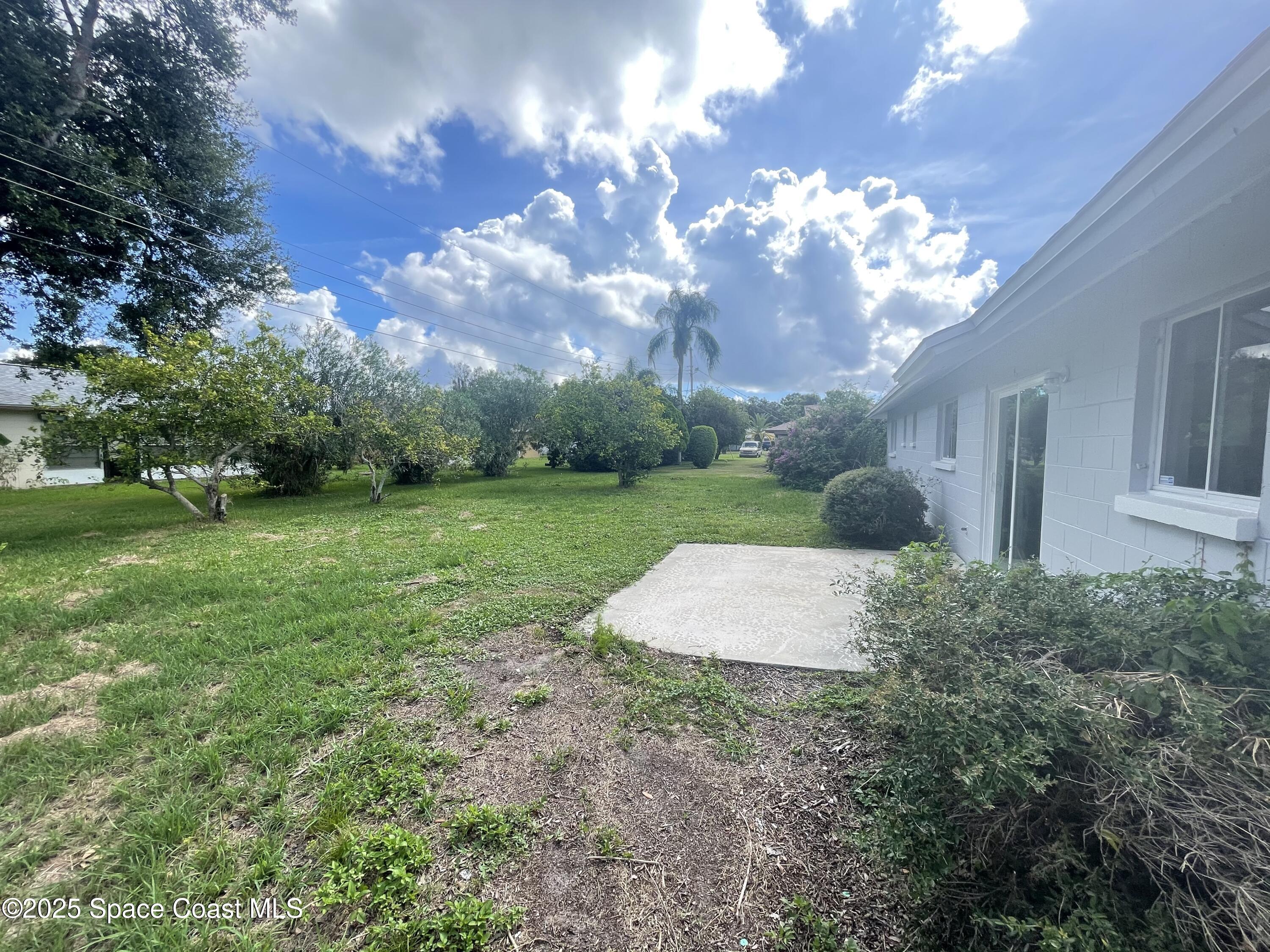 1118 Manatee Drive Rockledge, FL 32955 - Photo 15 of 17 a view of a house with a backyard