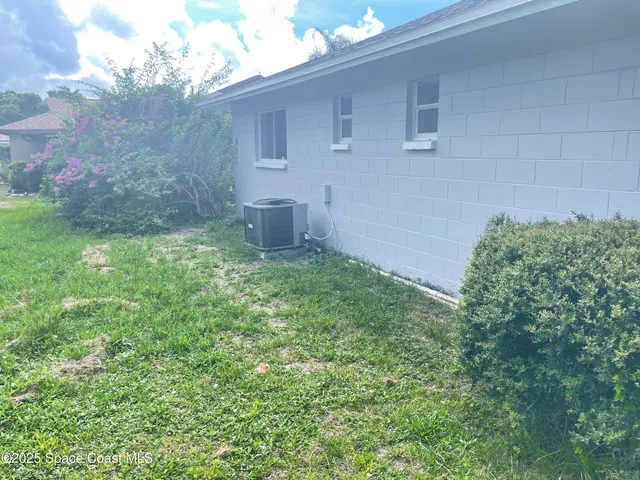 a backyard of a house with table and chairs