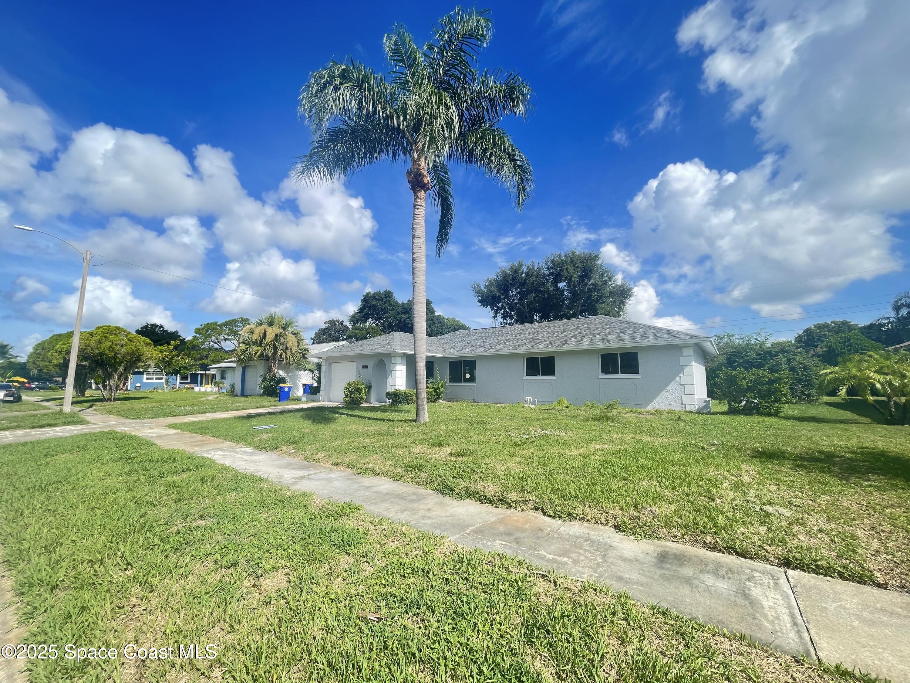 1118 Manatee Drive Rockledge, FL 32955 - Photo 3 of 17 a front view of a house with garden