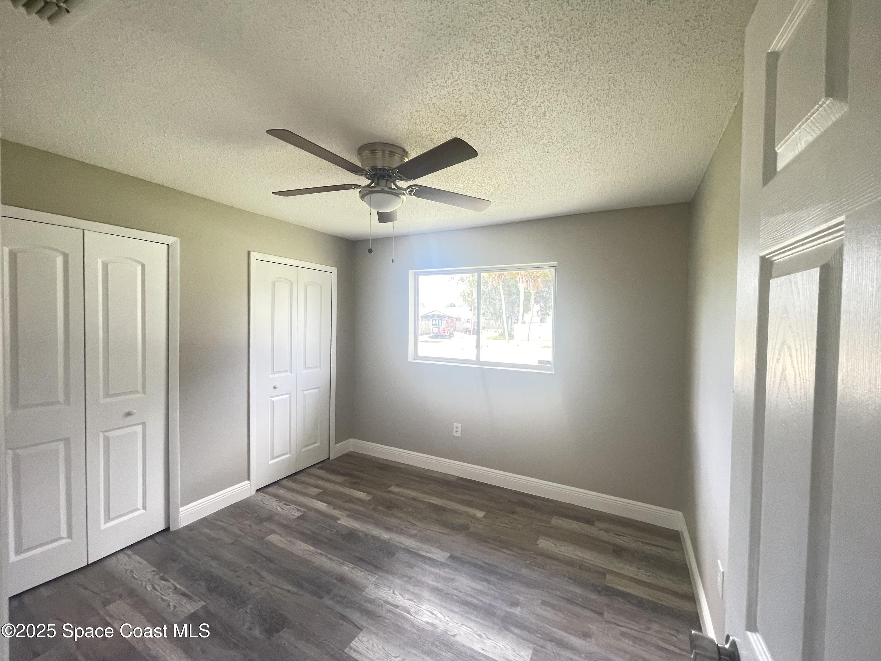 1118 Manatee Drive Rockledge, FL 32955 - Photo 10 of 17 a view of a big room with wooden floor and windows in a room