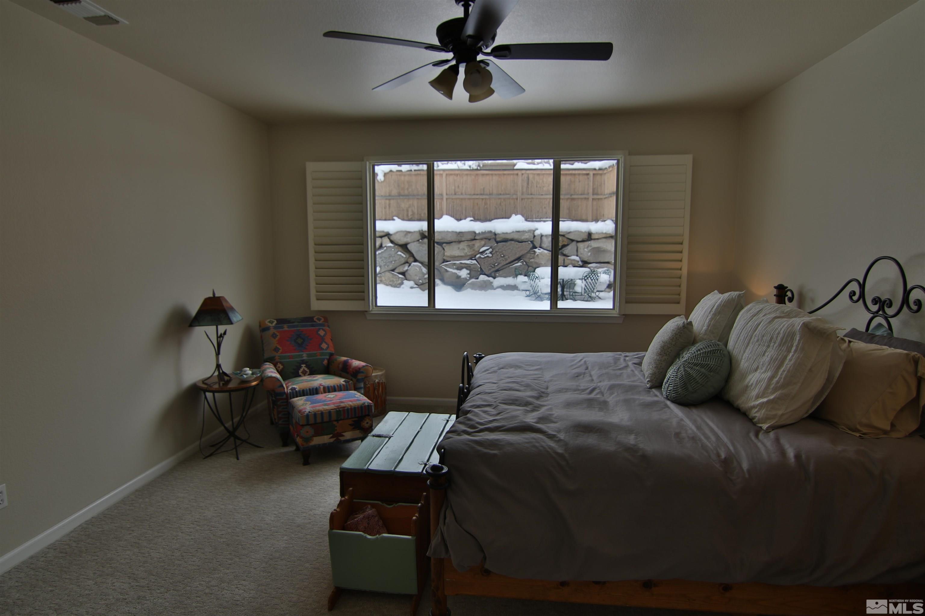 10640 Fire Poppy Circle Reno, NV 89521 - Photo 11 of 27 a bedroom with a bed couch and window
