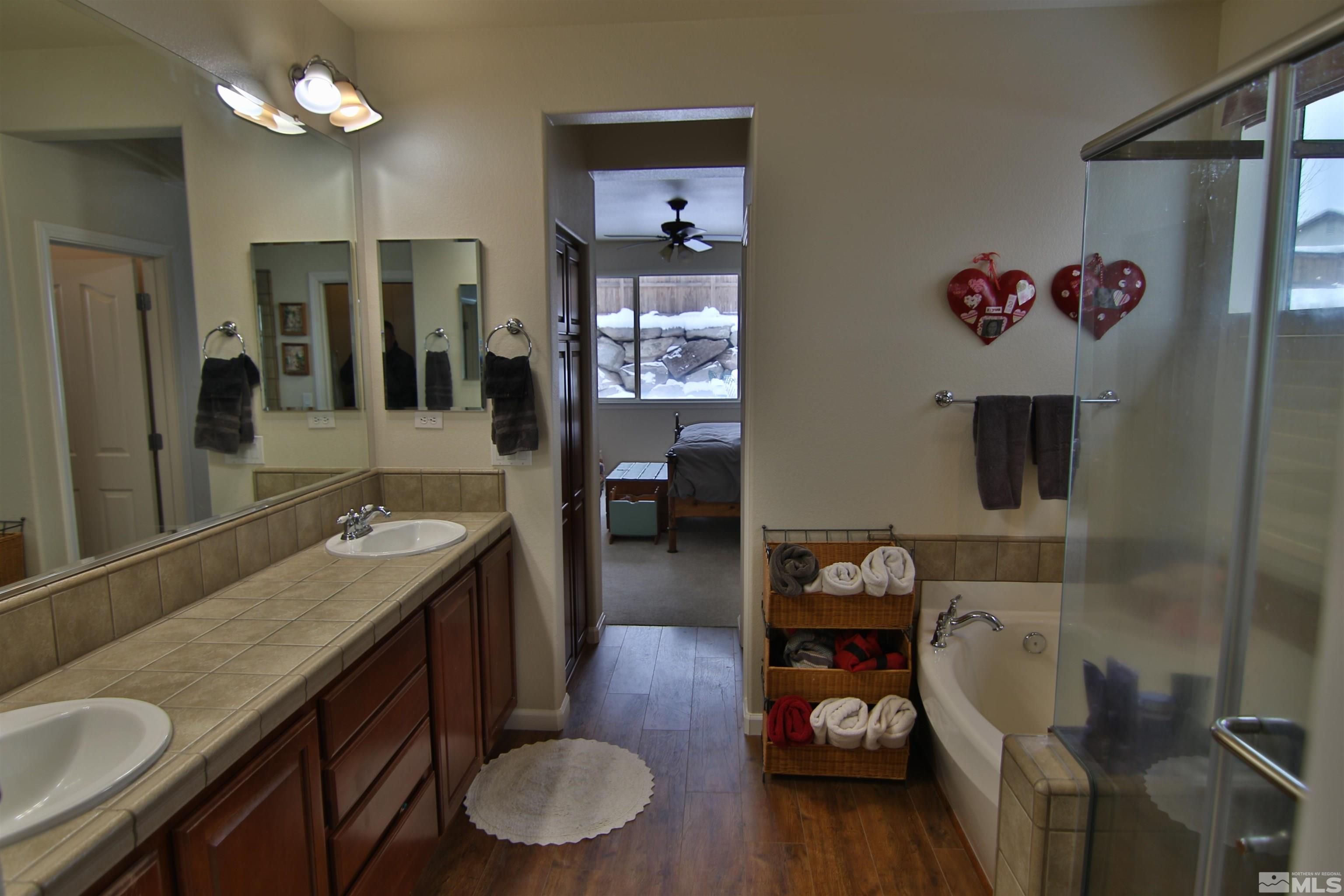 10640 Fire Poppy Circle Reno, NV 89521 - Photo 12 of 27 a bathroom with a granite countertop sink a mirror and vanity