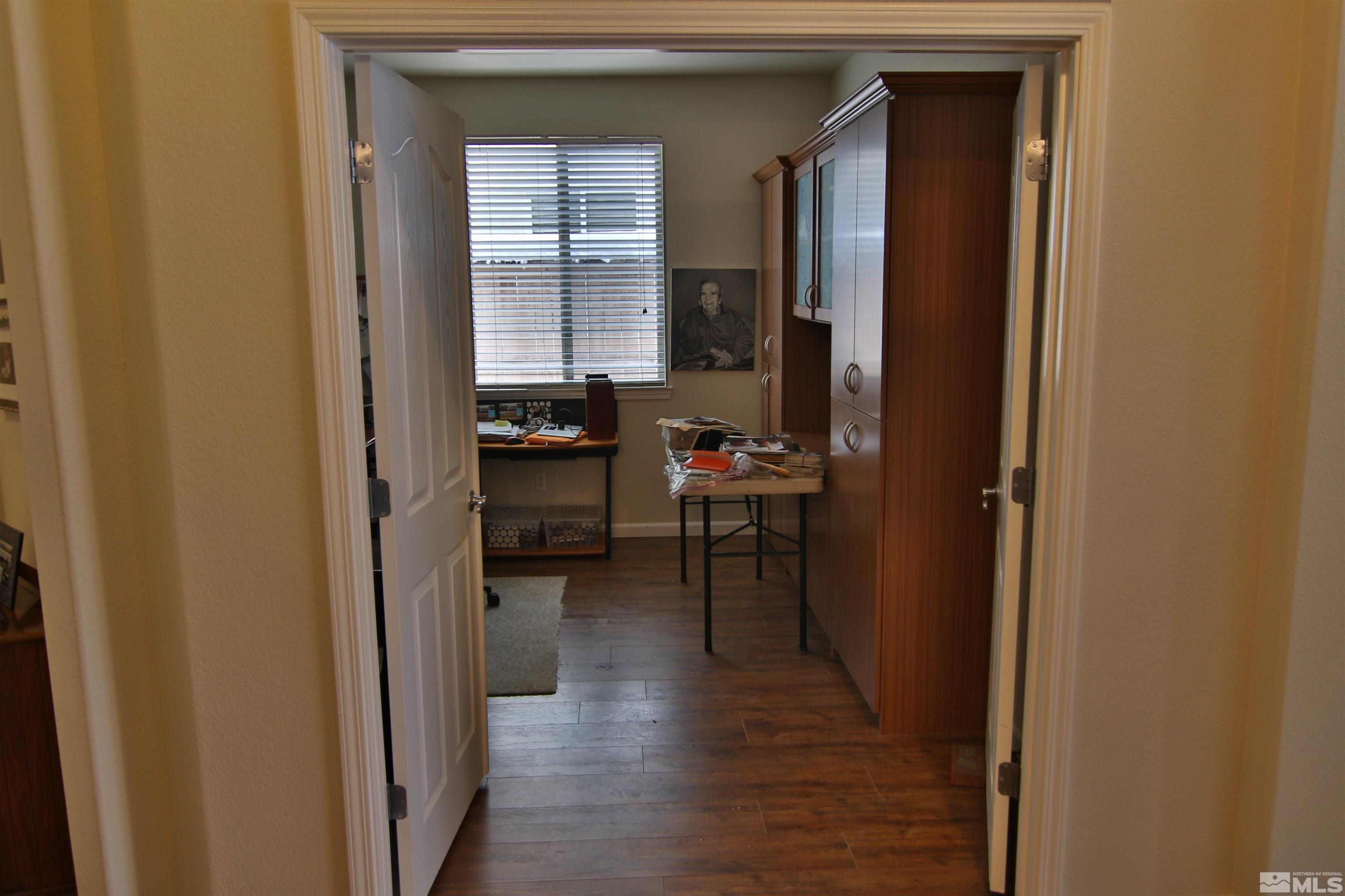 10640 Fire Poppy Circle Reno, NV 89521 - Photo 19 of 27 a view of a hallway with wooden floor and furniture