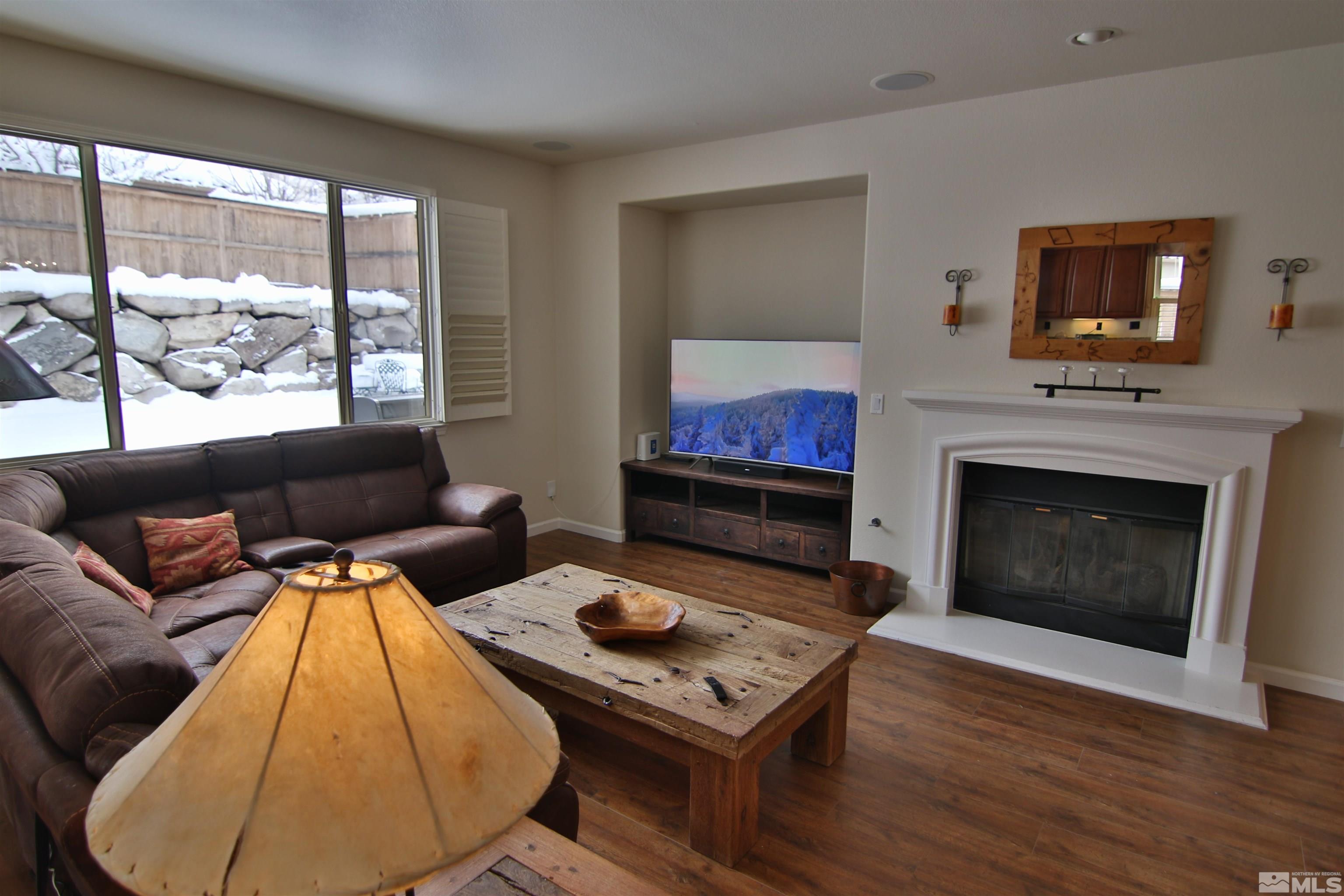 10640 Fire Poppy Circle Reno, NV 89521 - Photo 5 of 27 a living room with furniture a flat screen tv and a fireplace