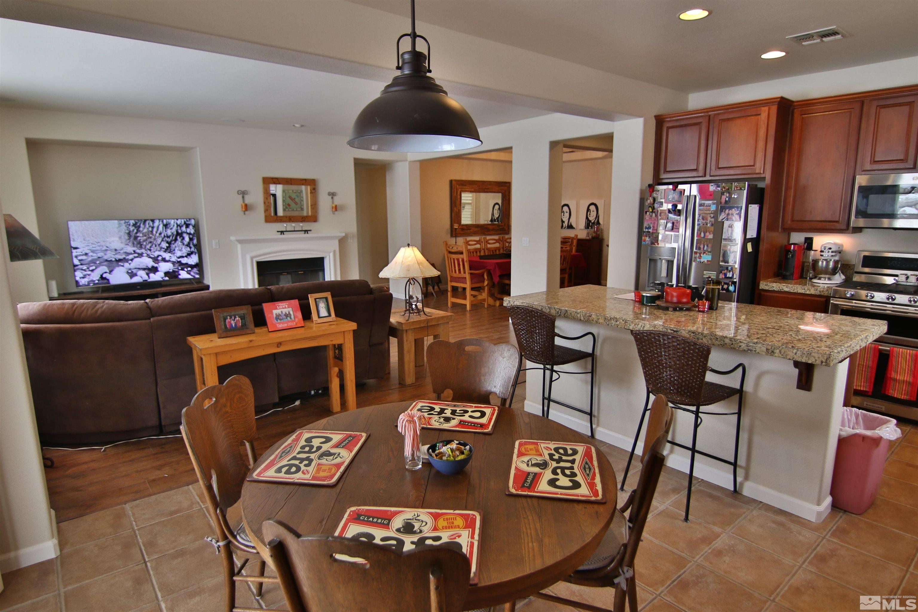 10640 Fire Poppy Circle Reno, NV 89521 - Photo 9 of 27 a living room with furniture a flat screen tv and kitchen view
