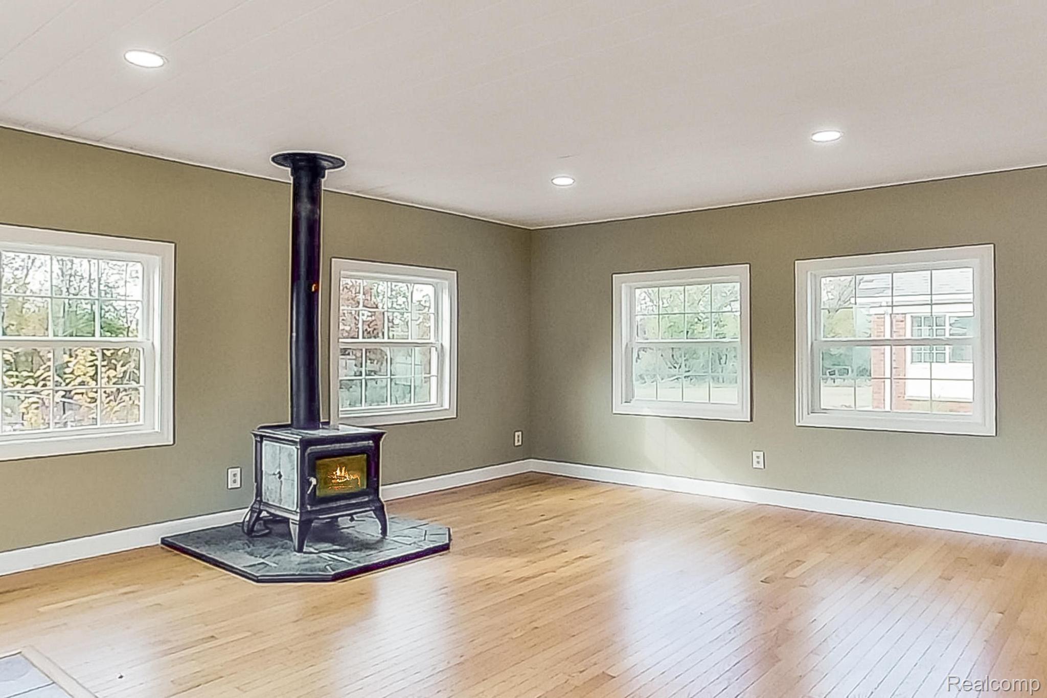 4374 Brogan Road Stockbridge, MI 49285 - Photo 28 of 94 3 season room off family room, wood burning stove