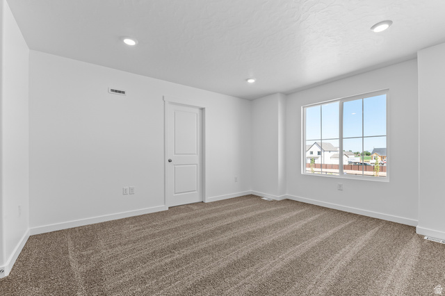 1851 East Corriente Drive, Unit 1166 Salem, UT 84653 - Photo 11 of 16 Spare room featuring dark carpet and recessed lighting