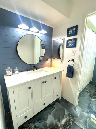 a bathroom with a double vanity sink and mirror
