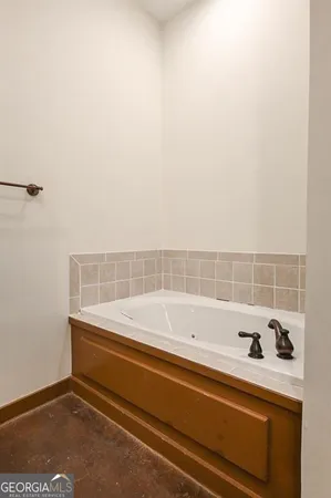 a bathroom with a bathtub and a window