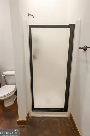 a bathroom with a toilet and a shower
