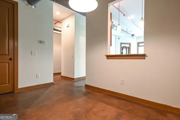 an empty room with windows and entrance