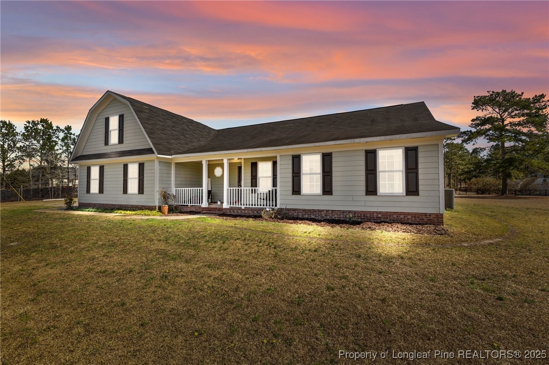 9619 Rockfish Road Raeford, NC 28376 - Photo 1 of 47 a front view of a house with a yard