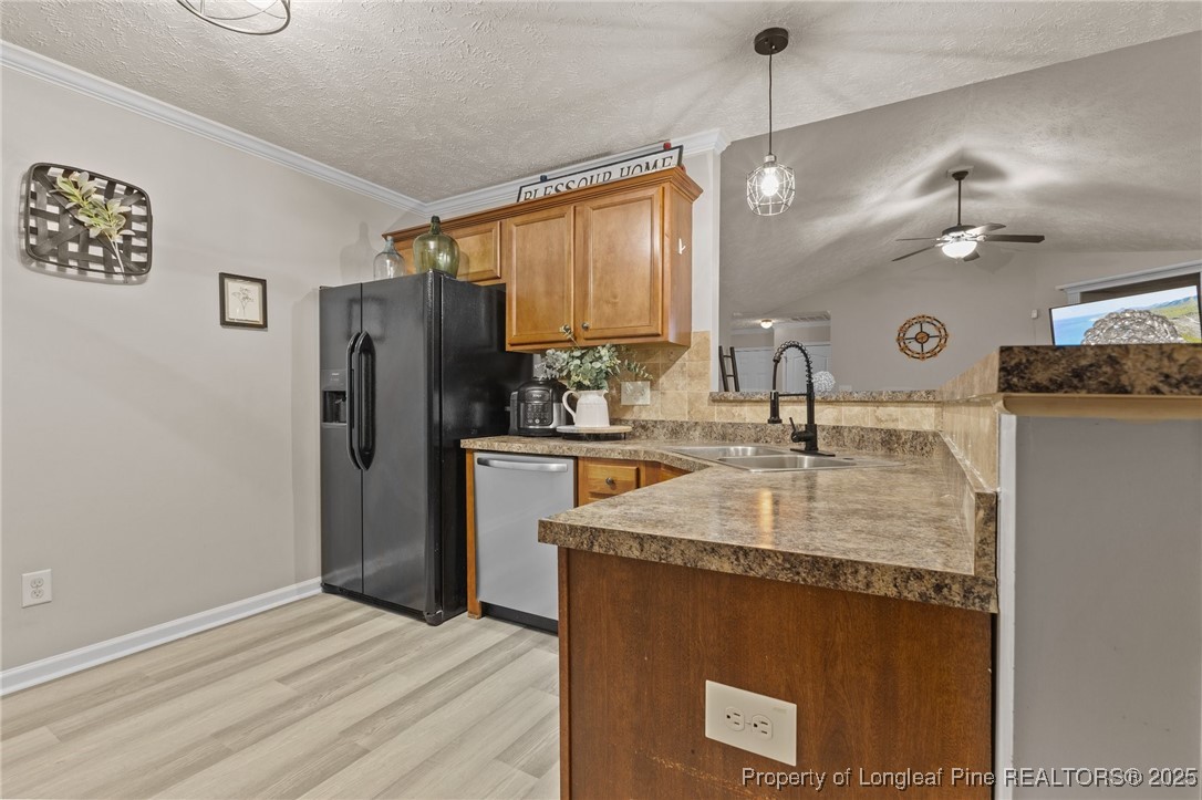 9619 Rockfish Road Raeford, NC 28376 - Photo 16 of 47 a kitchen with stainless steel appliances granite countertop a sink a refrigerator and a granite counter tops