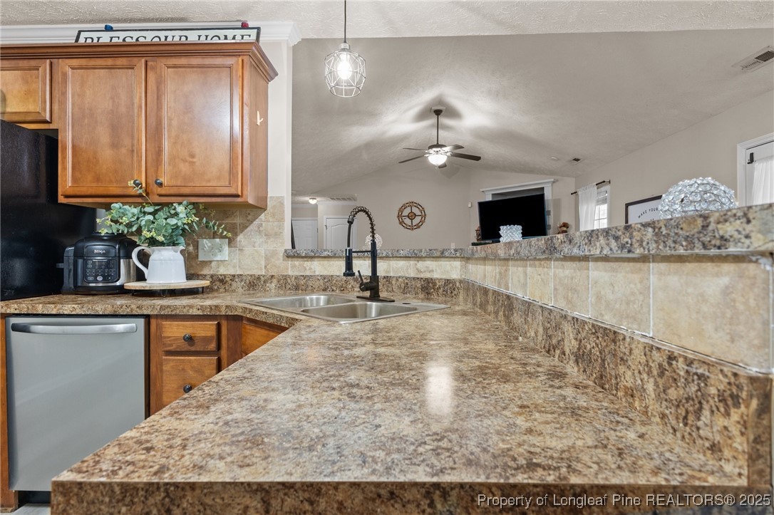 9619 Rockfish Road Raeford, NC 28376 - Photo 17 of 47 a kitchen with kitchen island granite countertop a sink stainless steel appliances and cabinets