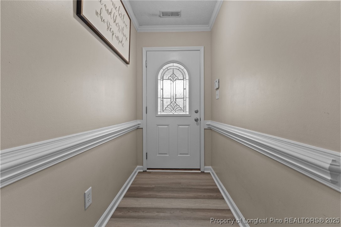 9619 Rockfish Road Raeford, NC 28376 - Photo 19 of 47 a view of a livingroom with wooden floor and white walls