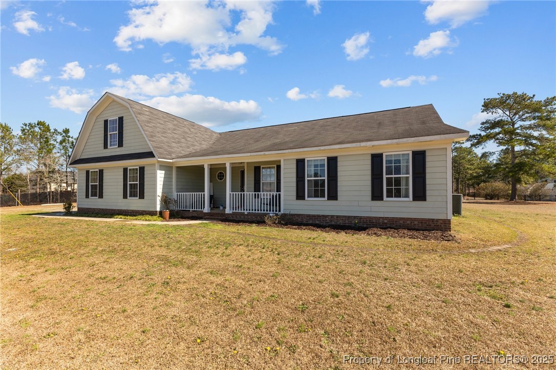 9619 Rockfish Road Raeford, NC 28376 - Photo 2 of 47 a front view of a house with a garden