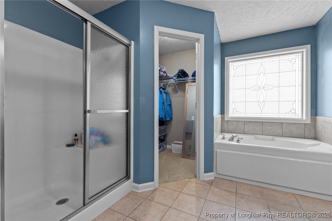 9619 Rockfish Road Raeford, NC 28376 - Photo 23 of 47 a bathroom with a tub and shower