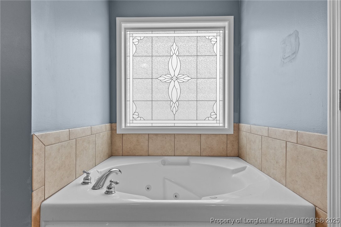 9619 Rockfish Road Raeford, NC 28376 - Photo 24 of 47 a bathroom with bathtub