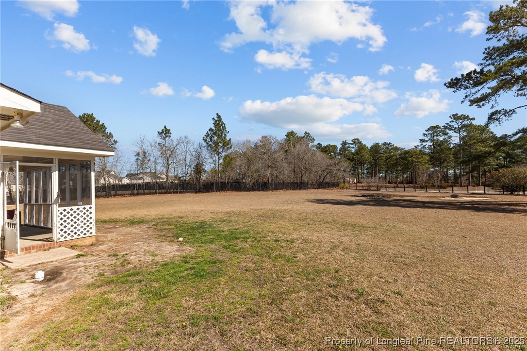 9619 Rockfish Road Raeford, NC 28376 - Photo 35 of 47 a view of three house with backyard and trees