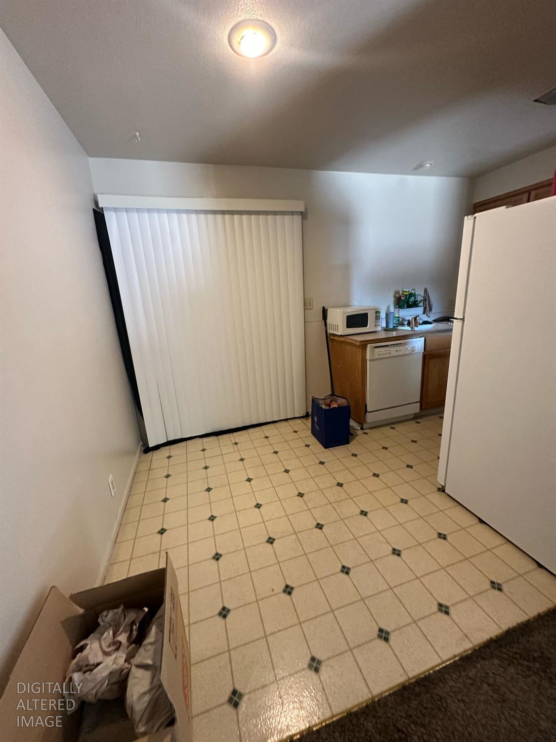114 College Avenue Modesto, CA 95350 - Photo 18 of 19 a room with a refrigerator and a window