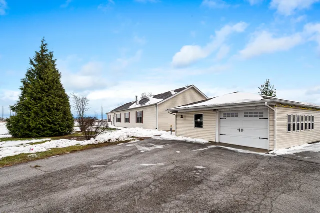 a view of a house with a snow on the road