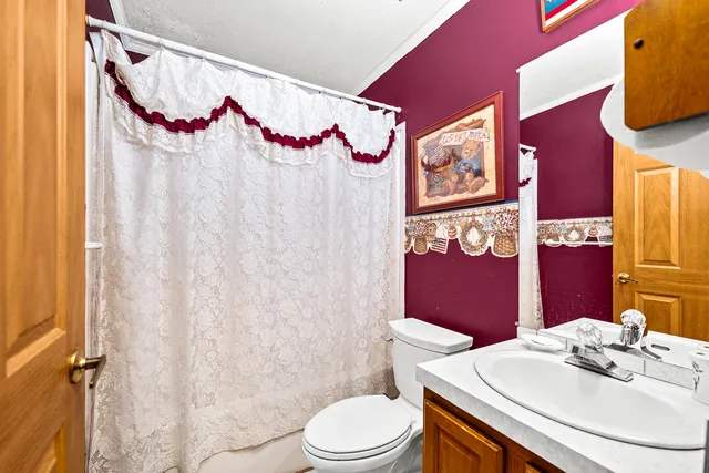 a view of a sink and a refrigerator in a kitchen
