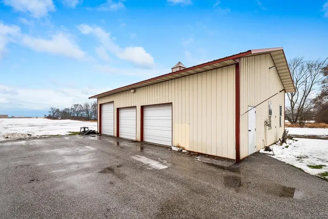 a view of a house with backyard and covered with snow