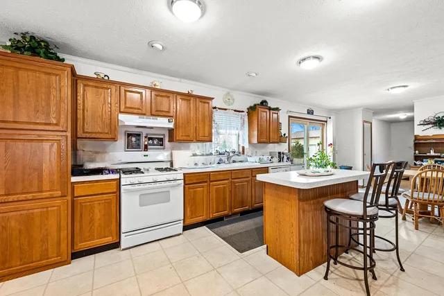 a kitchen with granite countertop appliances cabinets and furniture