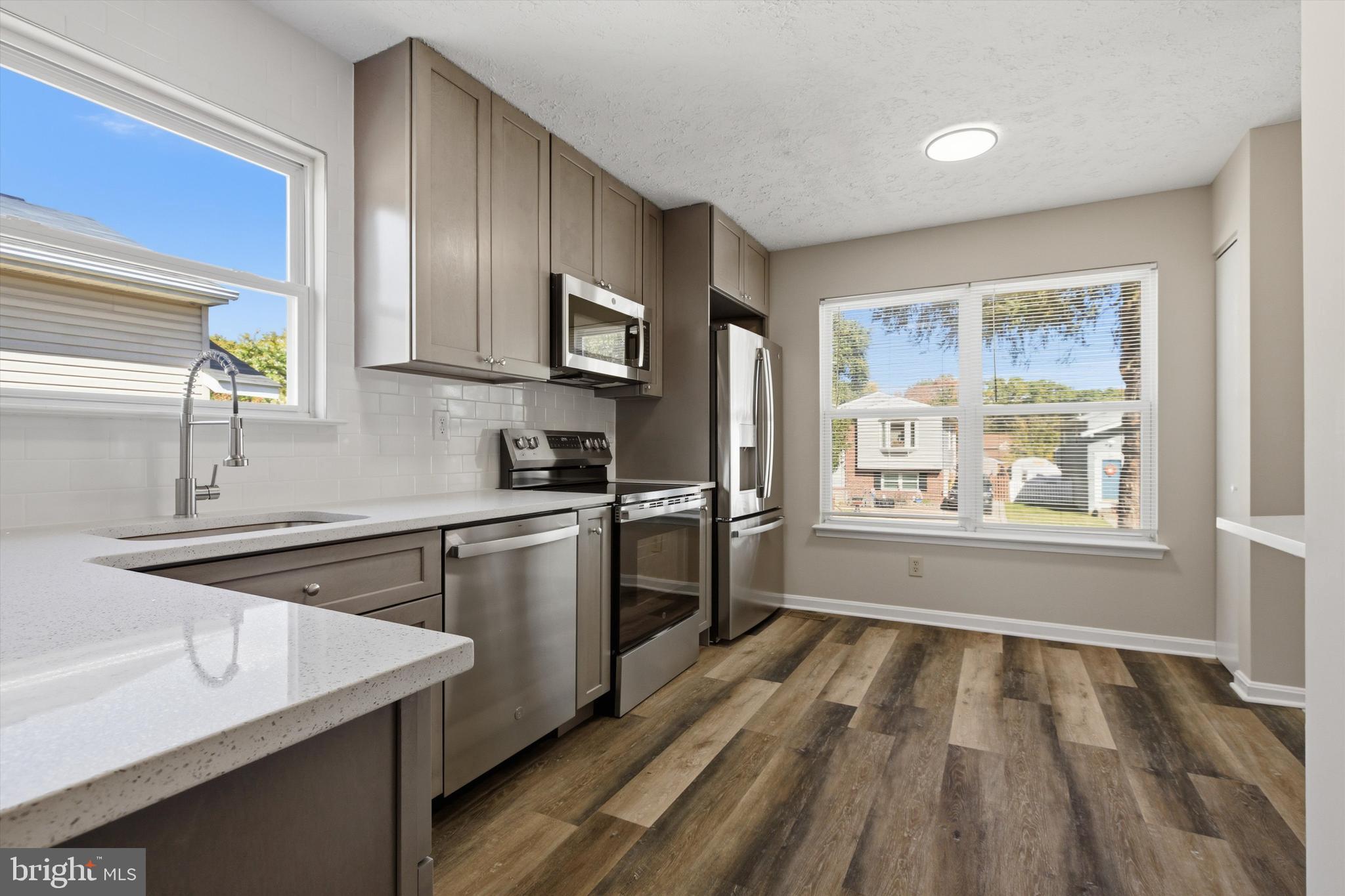 a kitchen with a sink stove and refrigerator