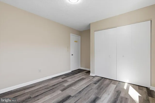 a view of a room with wooden floor and windows