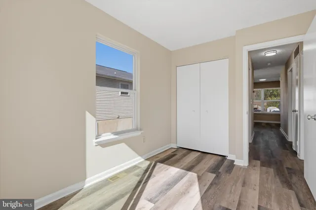 a view of a livingroom with wooden floor and stairs
