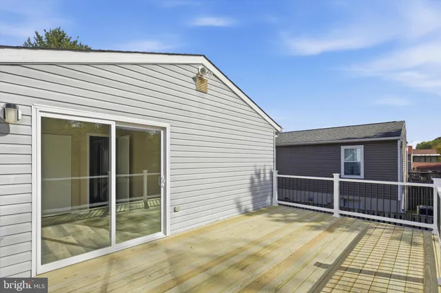 a view of a balcony with wooden floor and fence