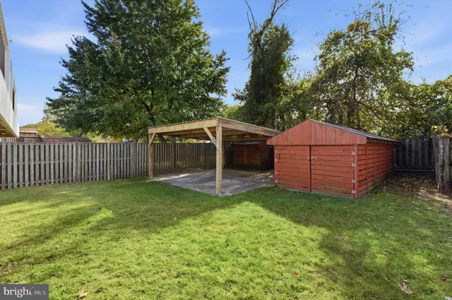 a view of house with backyard and a garden