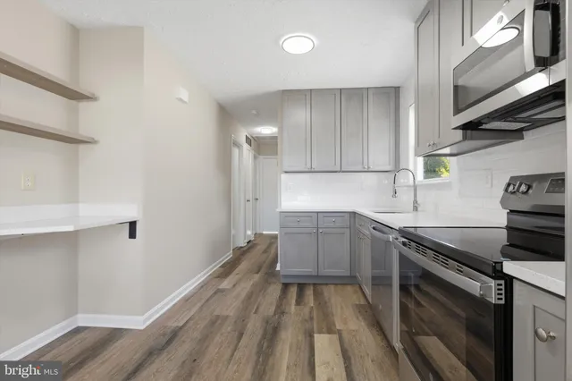 a kitchen with a sink and cabinets