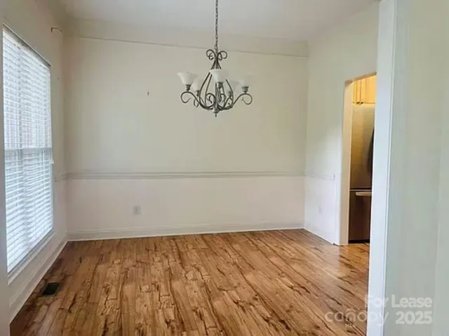 a view of a room with wooden floor
