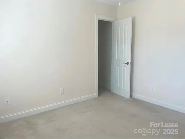 a view of a livingroom with an empty space and a window