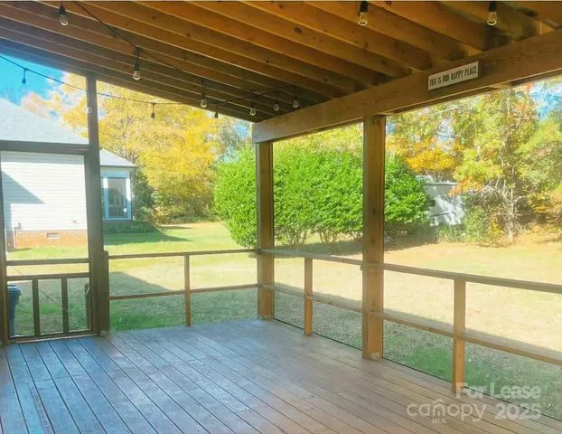 a view of a house with yard and wooden fence