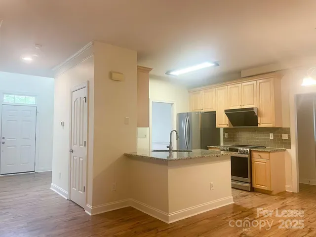 a kitchen with kitchen island counter top space and stainless steel appliances