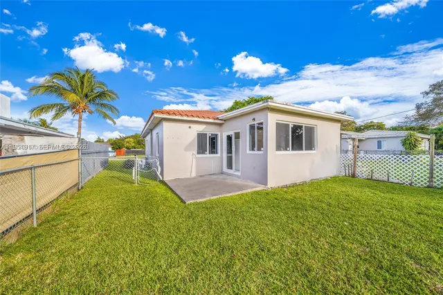 a view of a house with a backyard