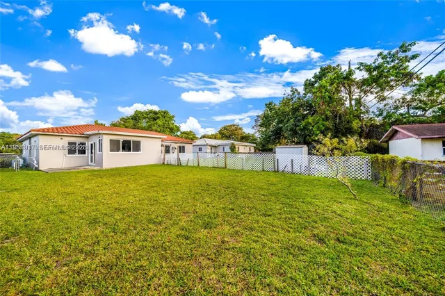 a front view of a house with a big yard