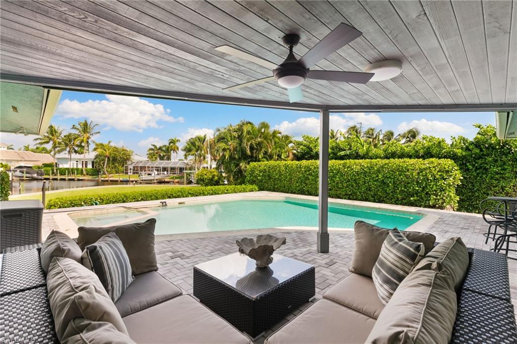 2140 Shad Court Naples, FL 34102 - Photo 23 of 44 a view of a patio with couches and pool