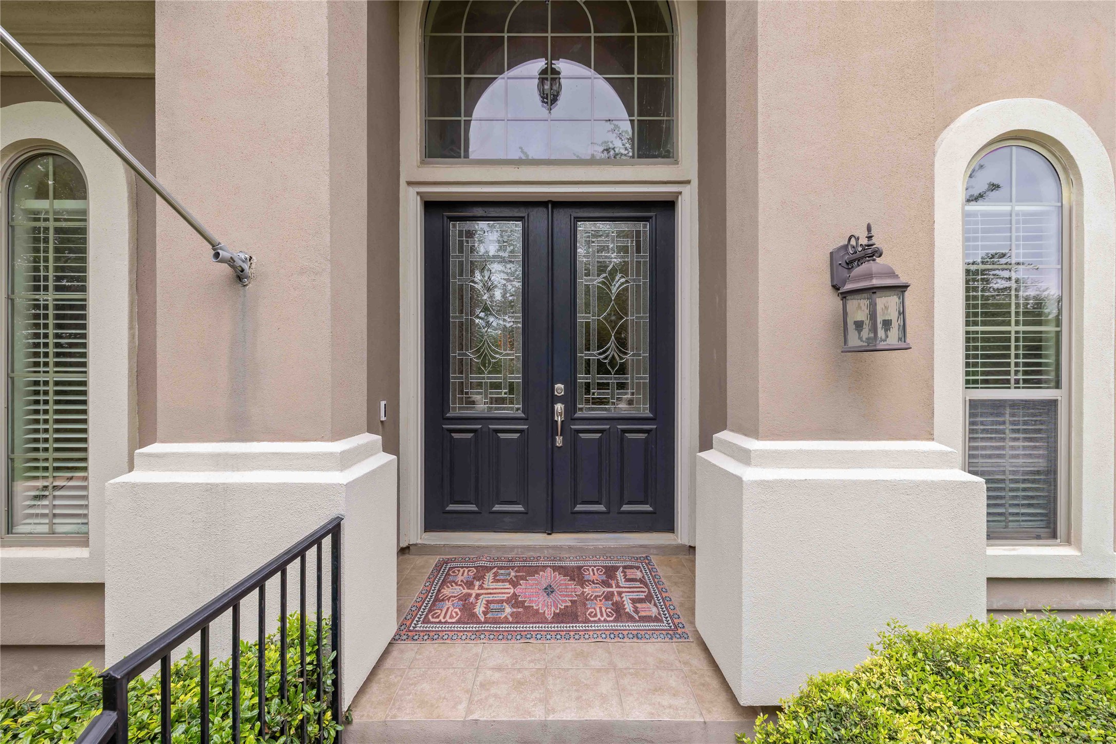 15200 Spillman Ranch Loop Austin, TX 78738 - Photo 2 of 40 The property features a grand entrance with double doors, intricate glass detailing, and an arched transom window