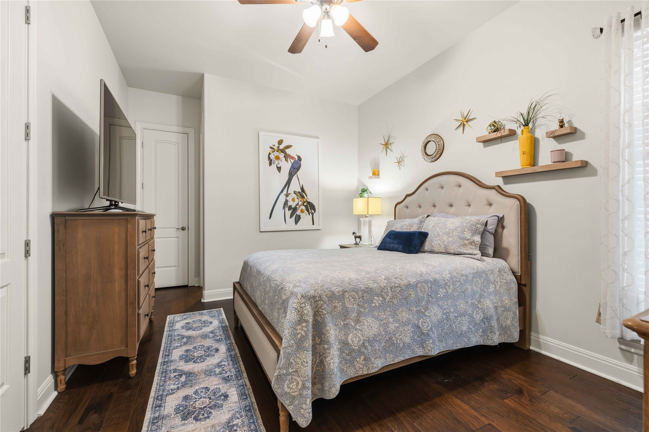 15200 Spillman Ranch Loop Austin, TX 78738 - Photo 21 of 40 This 2nd main level bedroom features rich, dark hardwood floors and a ceiling fan for comfort