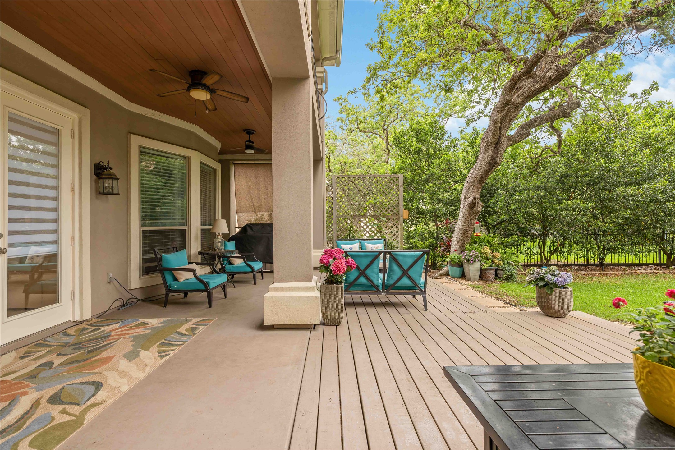15200 Spillman Ranch Loop Austin, TX 78738 - Photo 35 of 40 The property features a covered patio with a wooden ceiling and ceiling fans, leading to an open deck area